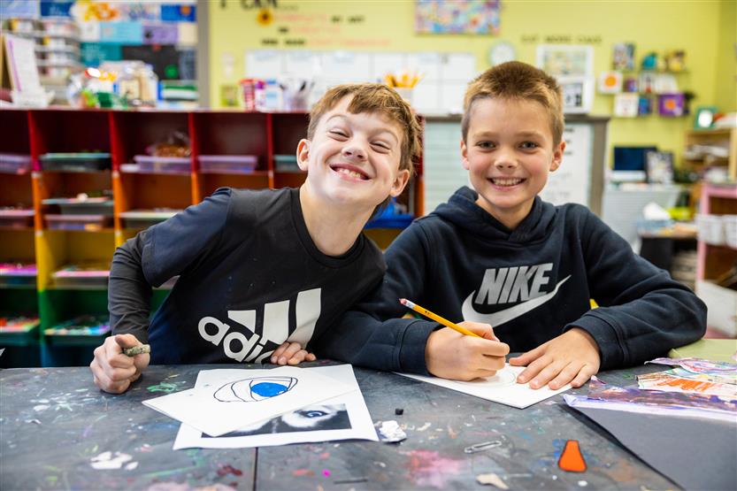Students in an art class using oil pastels